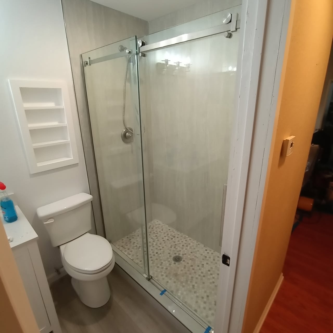 Bathroom remodel with a frameless glass shower and custom tile