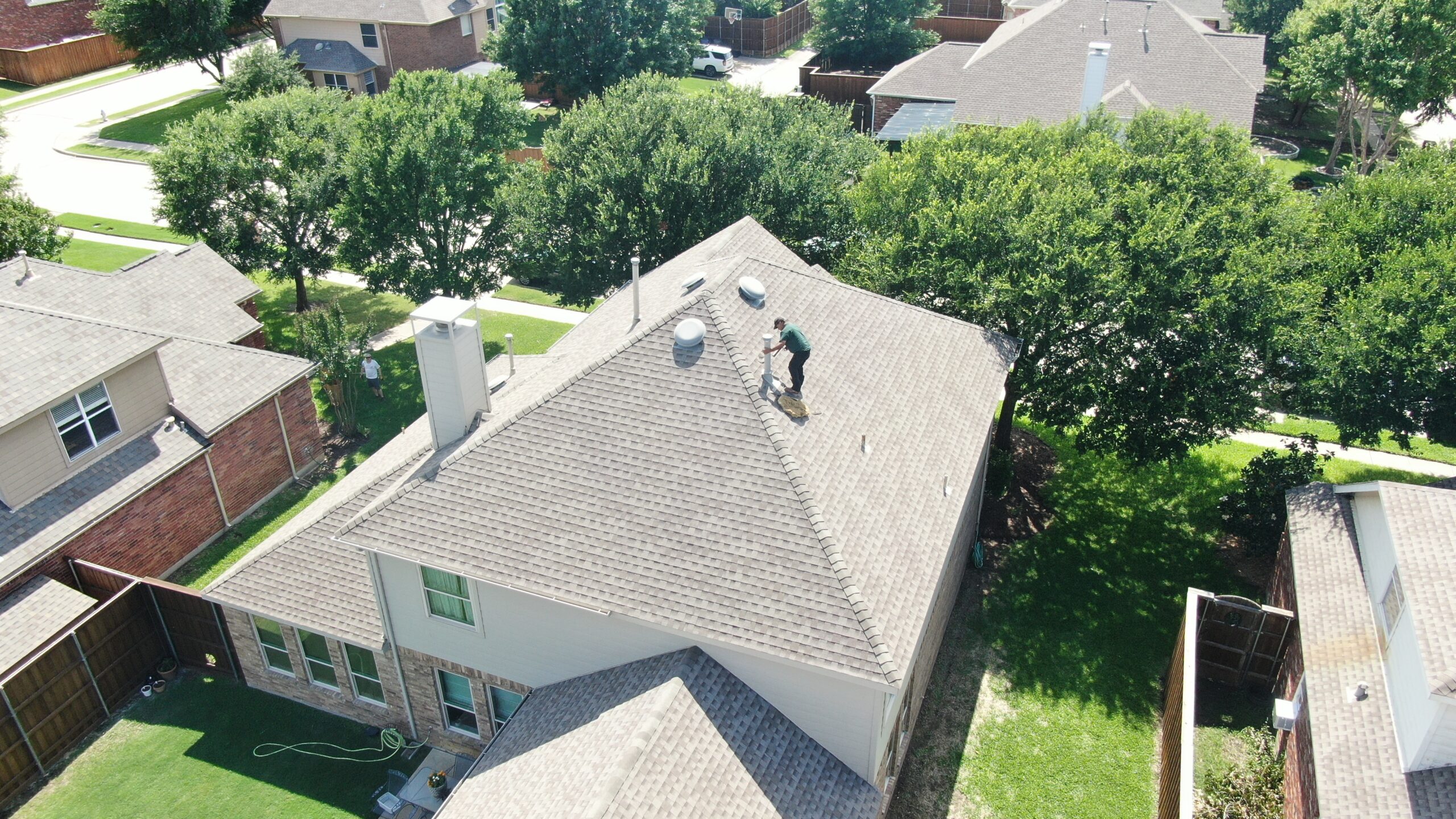 Aerial drone view of a storm-damage roof restoration in progress